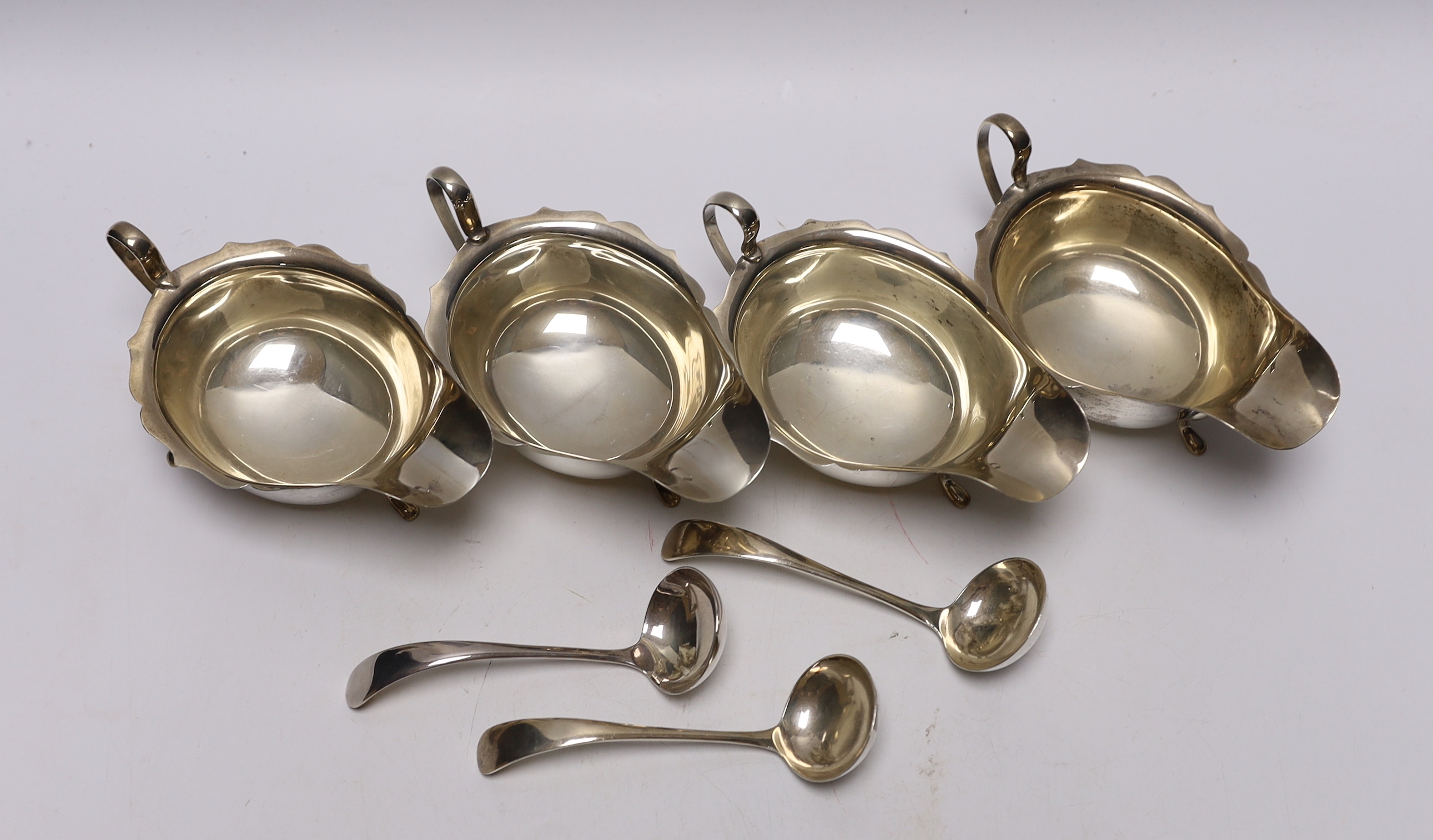 A set of three George VI silver sauceboats, Viners Ltd, Sheffield, 1937, together with three ladles (two silver) and one other silver sauceboat, 16.1oz.